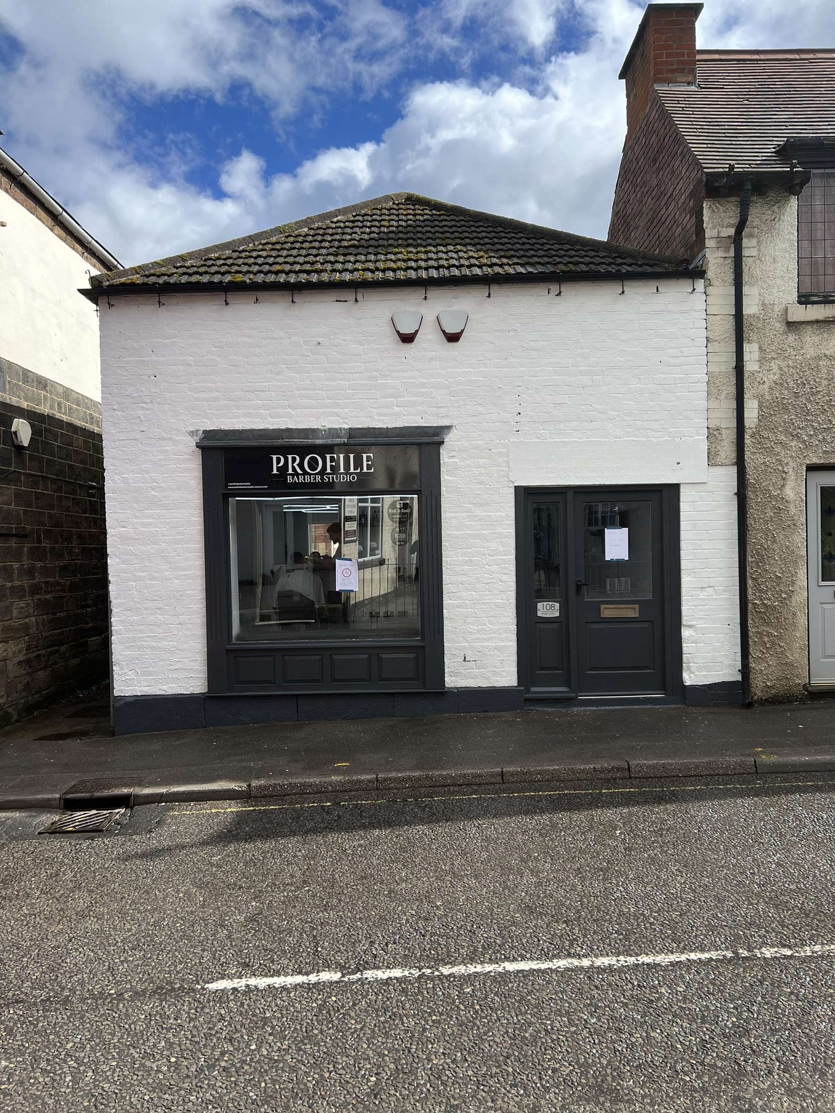 The Profile Barber Studio shopfront on Bridge Street: a white building with a black frontage