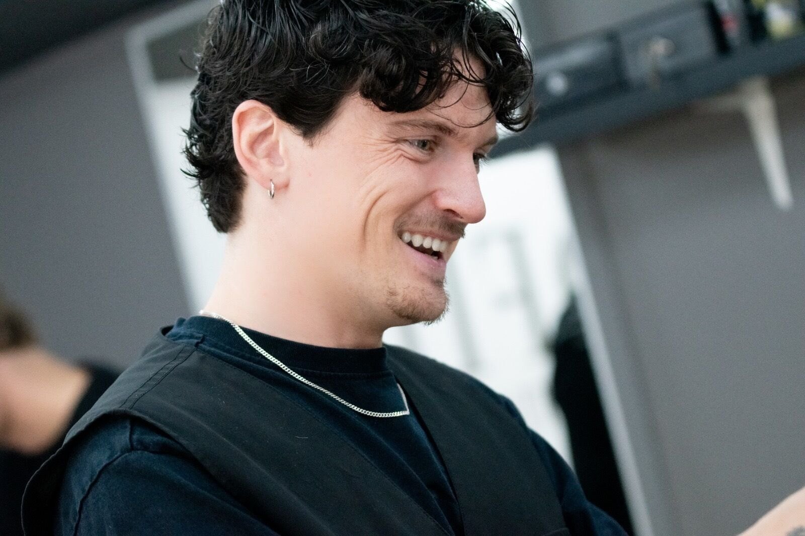 One of the Profile barbers smiling between cuts
